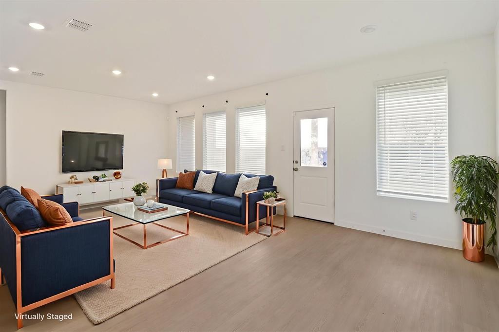 1016 Flameleaf Drive Princeton, TX 75407 - Photo 12 of 32 a living room with furniture and a flat screen tv