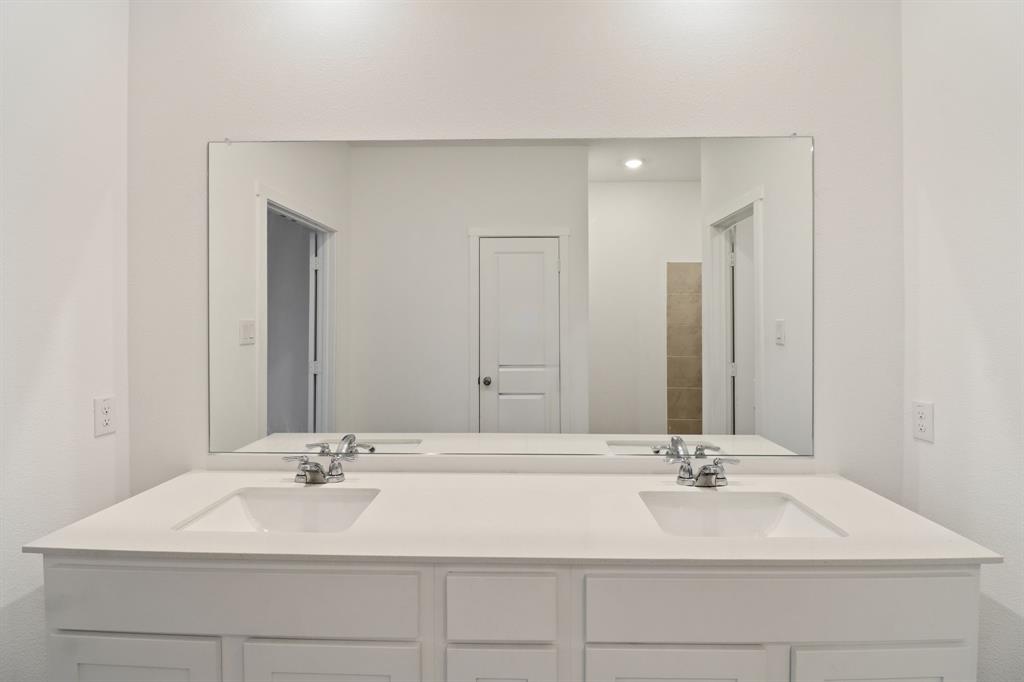 1016 Flameleaf Drive Princeton, TX 75407 - Photo 16 of 32 a bathroom with a sink double vanity and a mirror