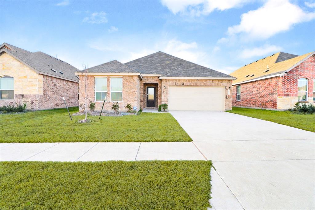 1016 Flameleaf Drive Princeton, TX 75407 - Photo 2 of 32 a front view of a house with a yard and garage