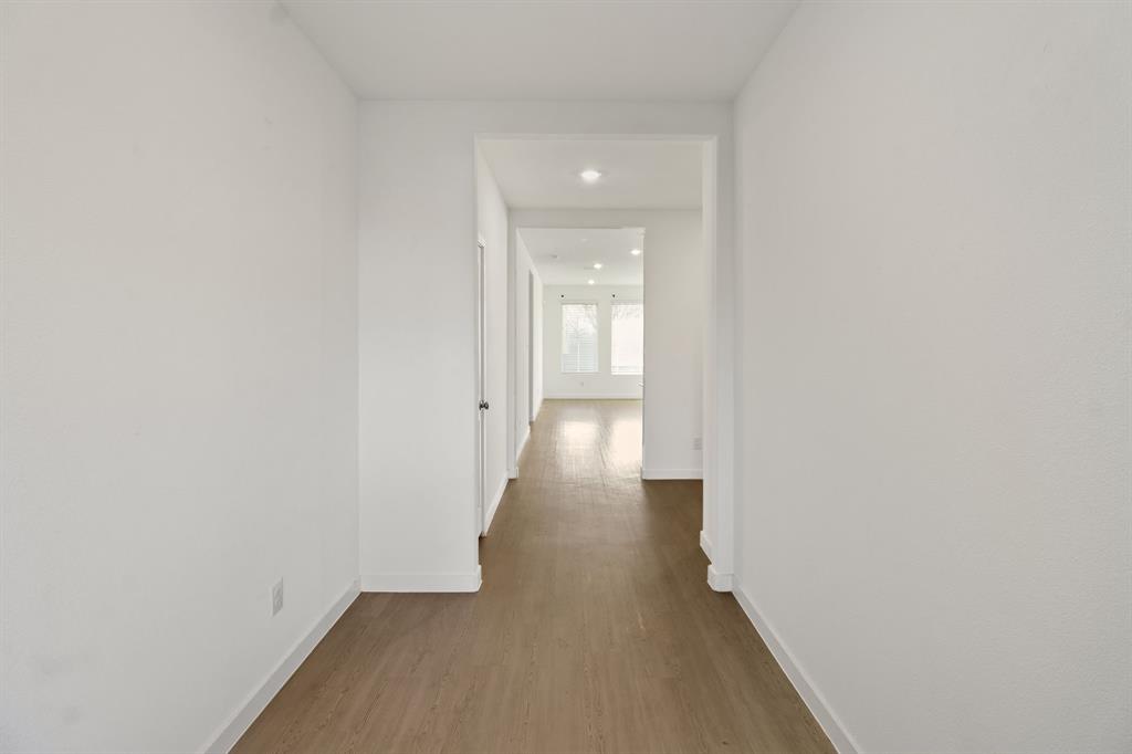 1016 Flameleaf Drive Princeton, TX 75407 - Photo 7 of 32 a view of a hallway with wooden floor