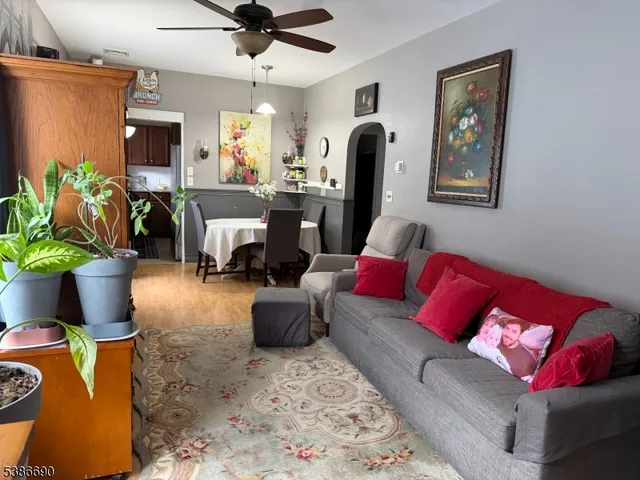 a living room with furniture and a potted plant