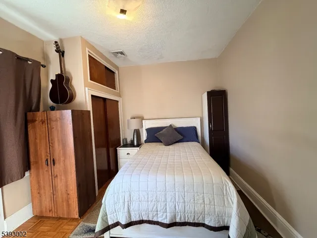 a bedroom with a bed a mirror and a window