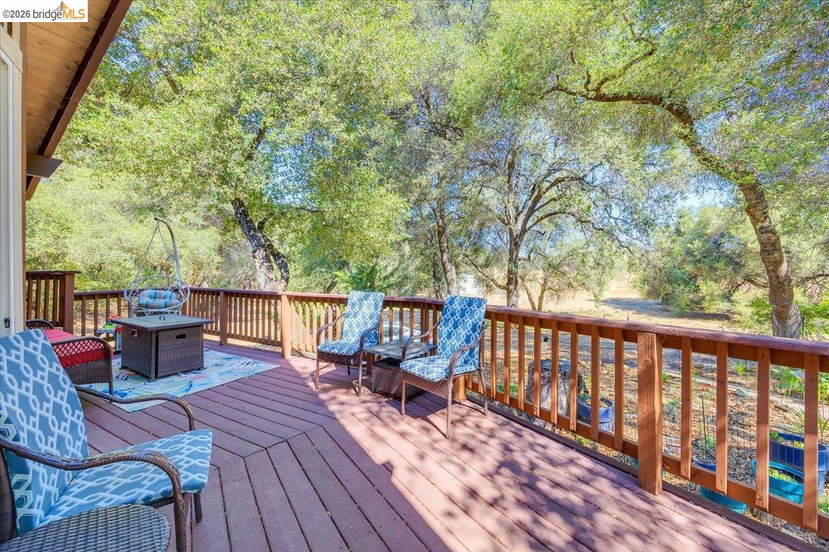 8733 Fraguero Road Sonora, CA 95370 - Photo 16 of 73 Expansive outdoor deck with rich wood-finish flooring and a sturdy wood railing