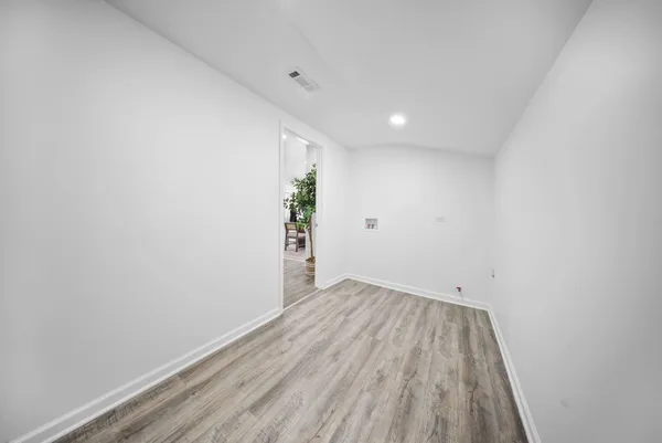a view of a room with wooden floor and window
