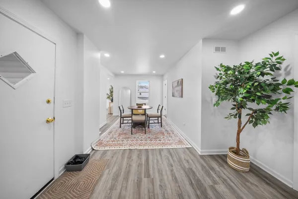 a living room with furniture and a potted plant