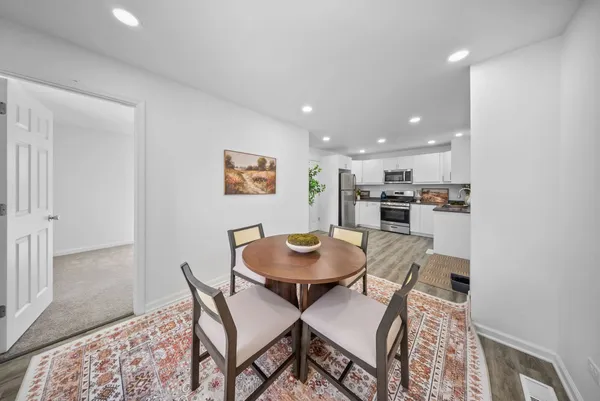 a view of a dining room with furniture and wooden floor