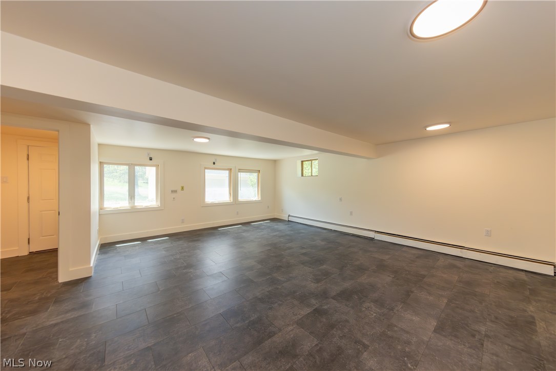 7969 Dines Road Novelty, OH 44072 - Photo 39 of 48 Spacious media room featuring dark tile flooring, multiple windows, and recessed lighting