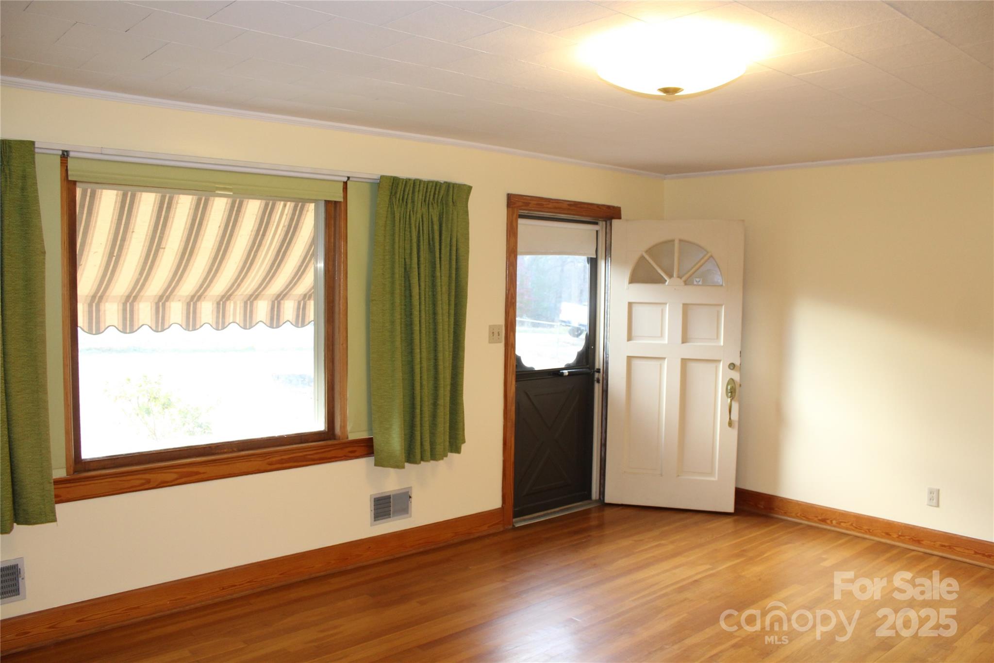 1761 Dearborn Street Morganton, NC 28655 - Photo 12 of 34 a view of an empty room with wooden floor and a window