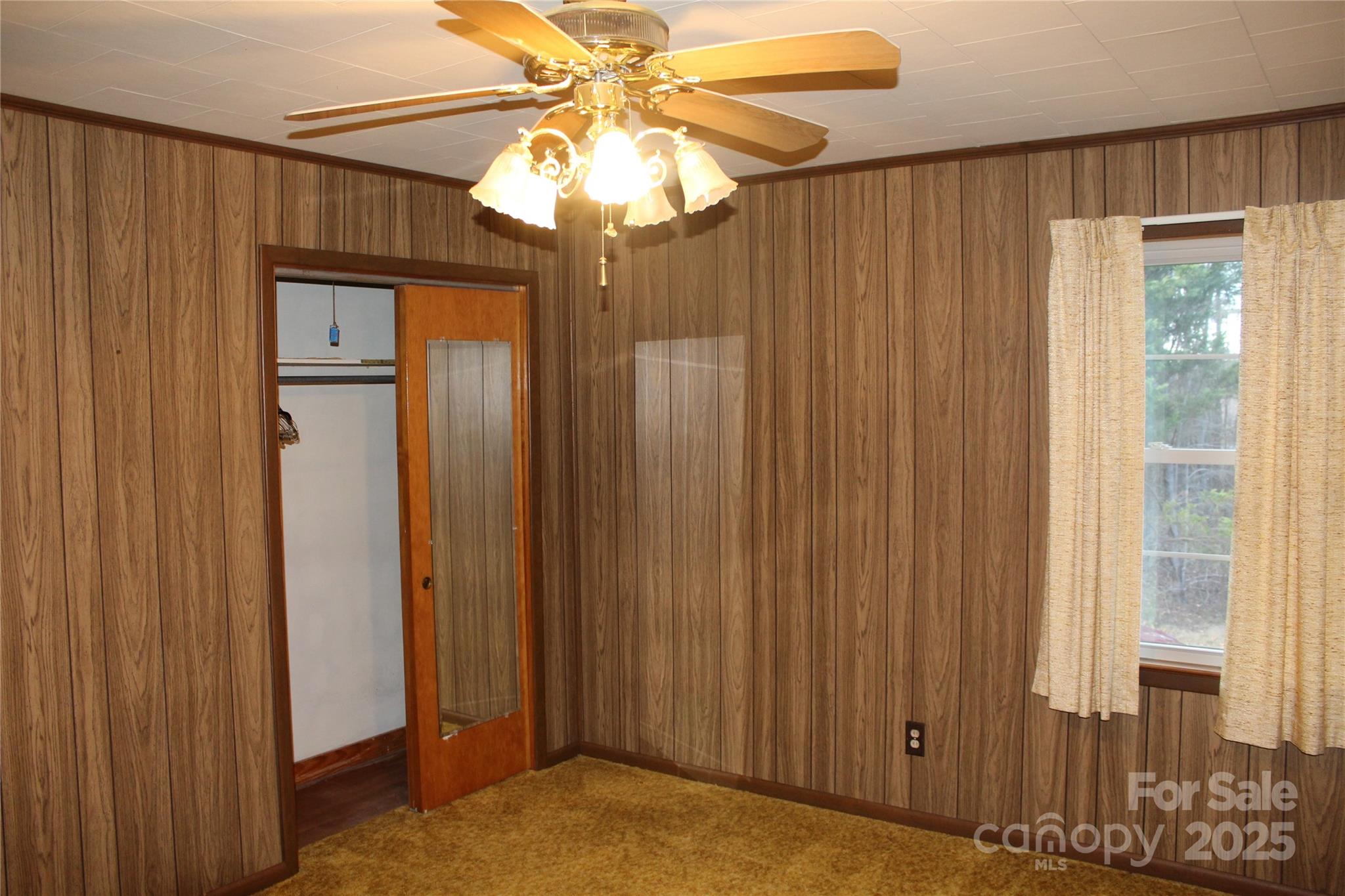 1761 Dearborn Street Morganton, NC 28655 - Photo 17 of 34 a view of a bedroom with closet and chandelier fan