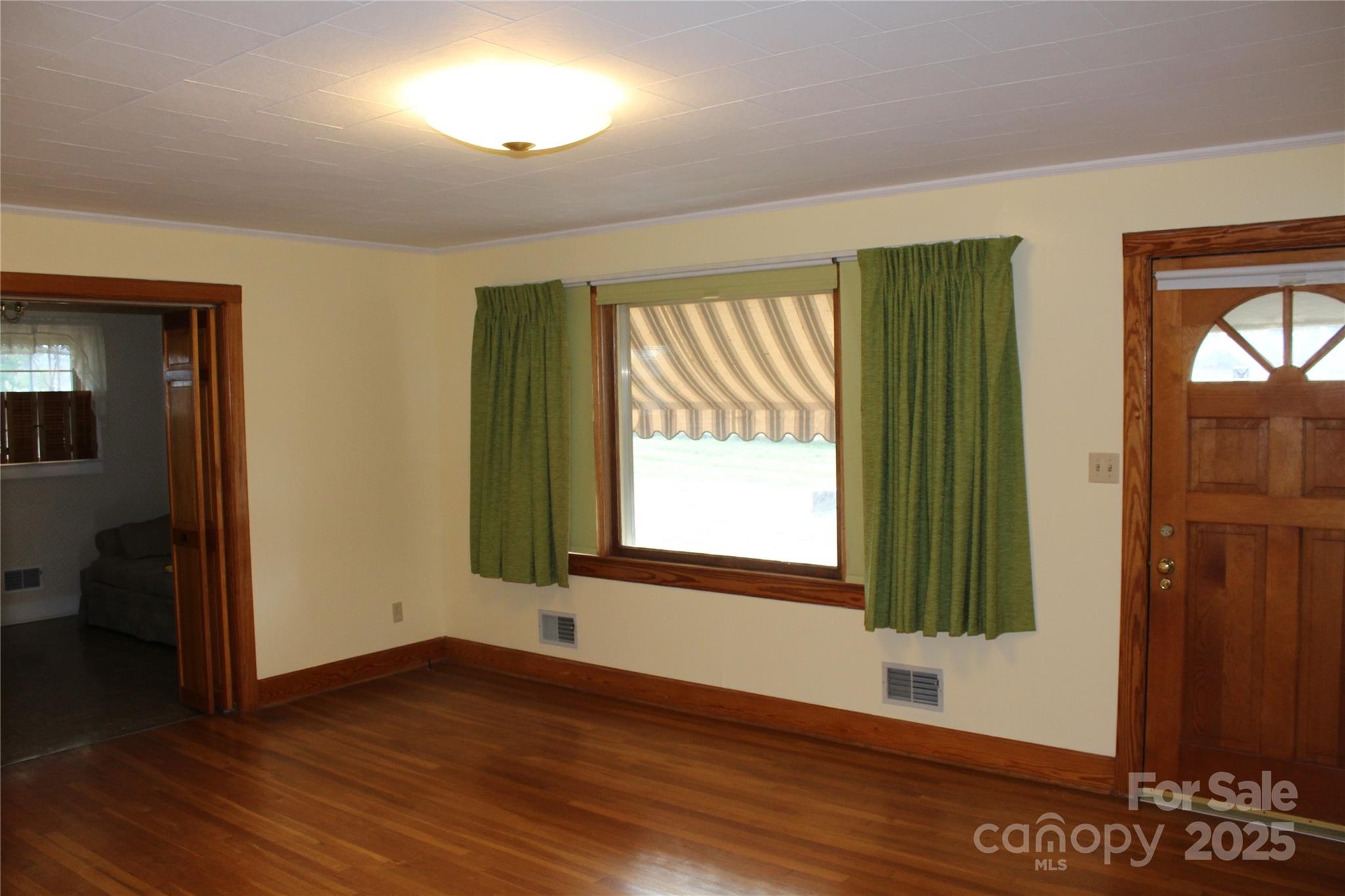 1761 Dearborn Street Morganton, NC 28655 - Photo 21 of 34 an empty room with wooden floor and a window