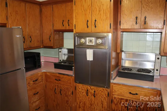 a kitchen with stainless steel appliances granite countertop a refrigerator and a stove
