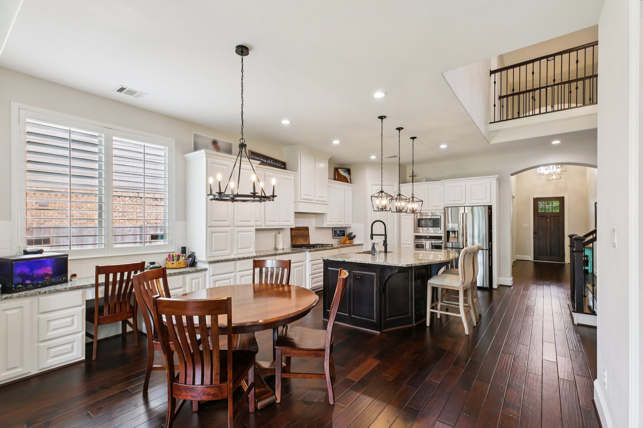 27914 Arden Trail Spring, TX 77386 - Photo 12 of 49 Bright, open-concept kitchen featuring white cabinetry, granite countertops, large island, and stainless steel appliances. Recessed lighting and abundant natural light create a warm, inviting space perfect for everyday living and entertaining.