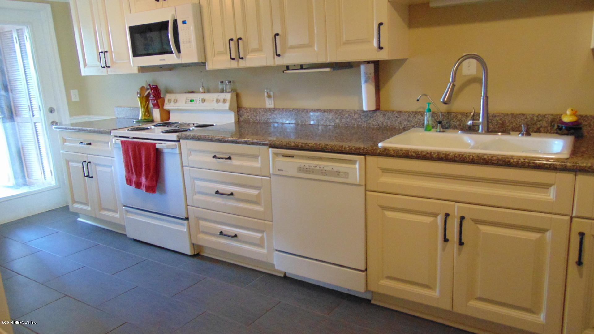4636 Manchester Road Jacksonville, FL 32210 - Photo 2 of 9 a kitchen with cabinets appliances and a sink