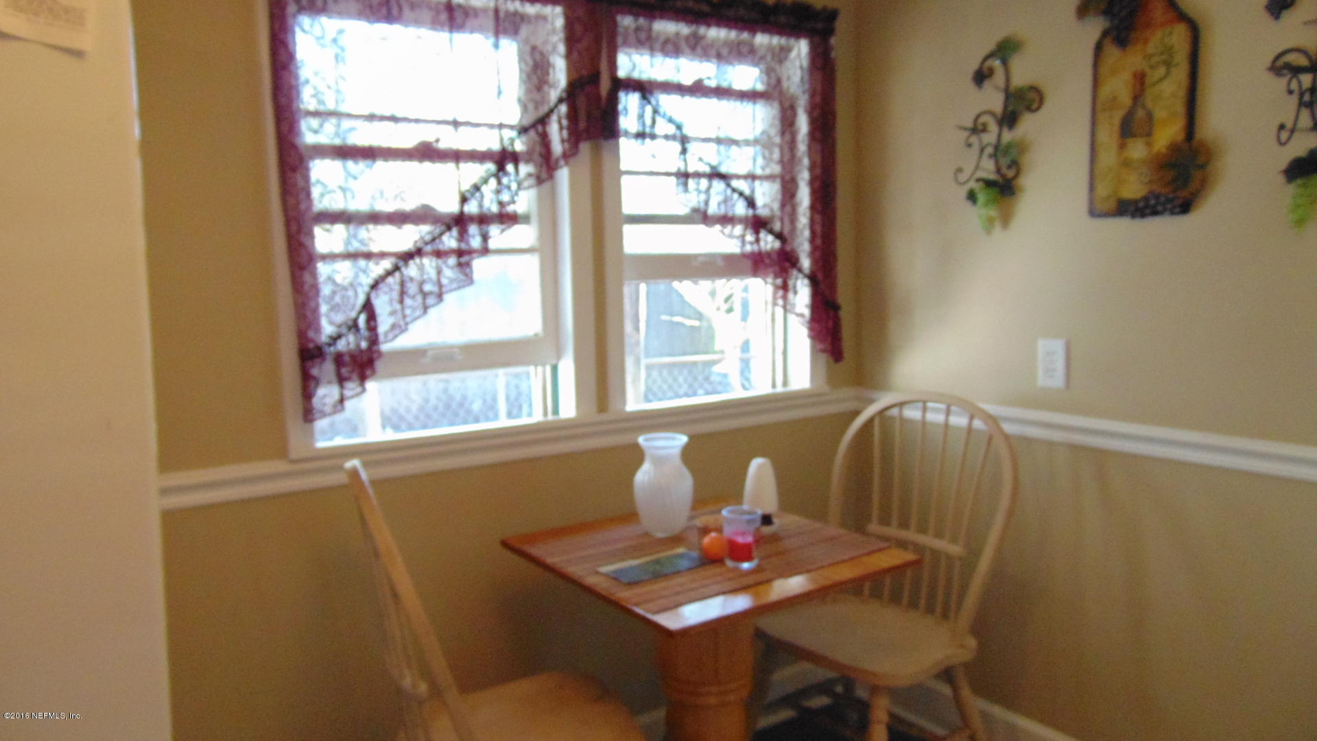 4636 Manchester Road Jacksonville, FL 32210 - Photo 3 of 9 a view of a dining room with furniture and window