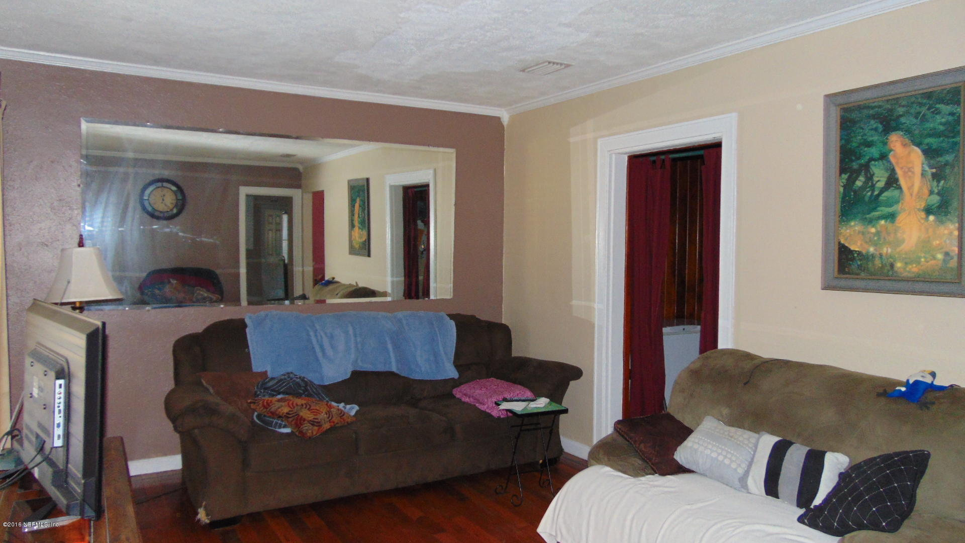 4636 Manchester Road Jacksonville, FL 32210 - Photo 4 of 9 a living room with furniture and a window
