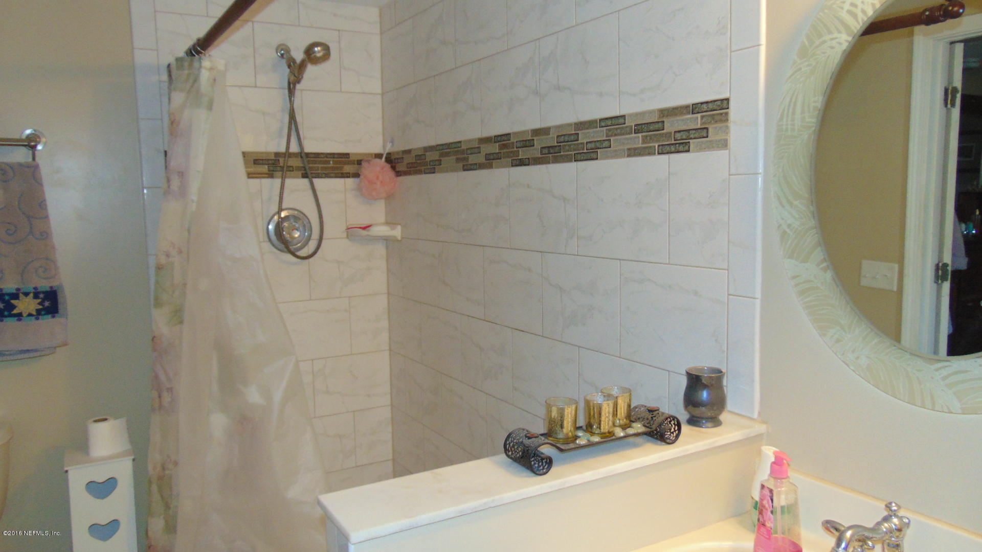 4636 Manchester Road Jacksonville, FL 32210 - Photo 5 of 9 a bathroom with a sink and shower