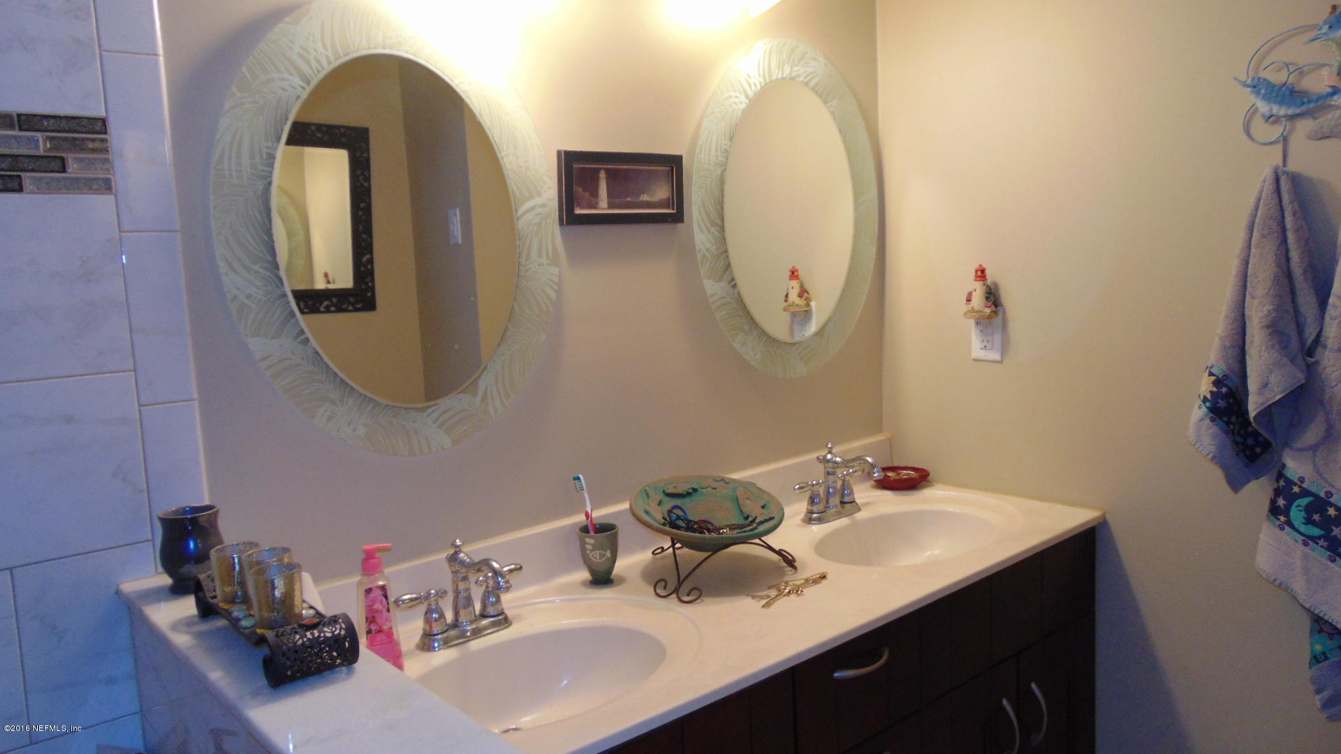 4636 Manchester Road Jacksonville, FL 32210 - Photo 6 of 9 a bathroom with a sink and a mirror