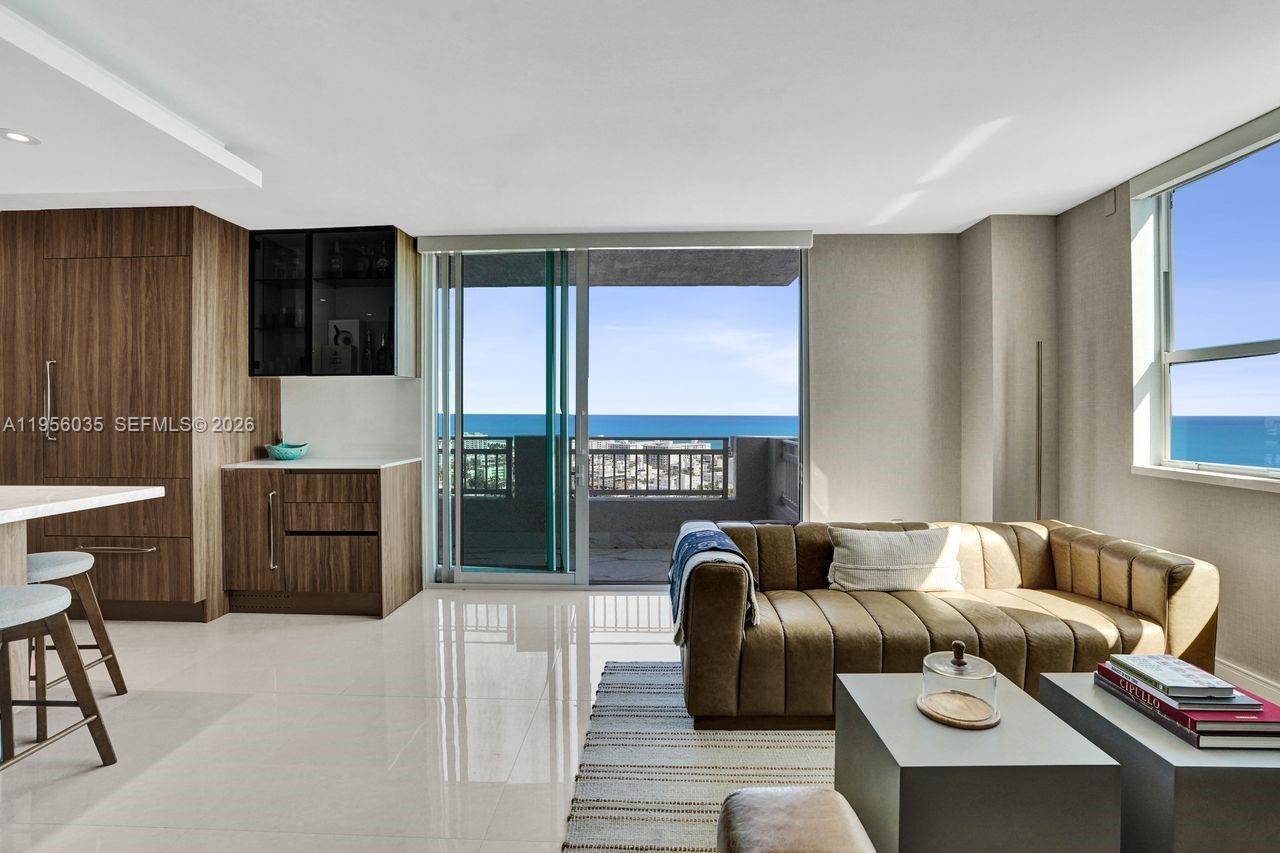 90 Alton Road, Unit 2701 Miami Beach, FL 33139 - Photo 23 of 76 a living room with furniture a fireplace and a large window