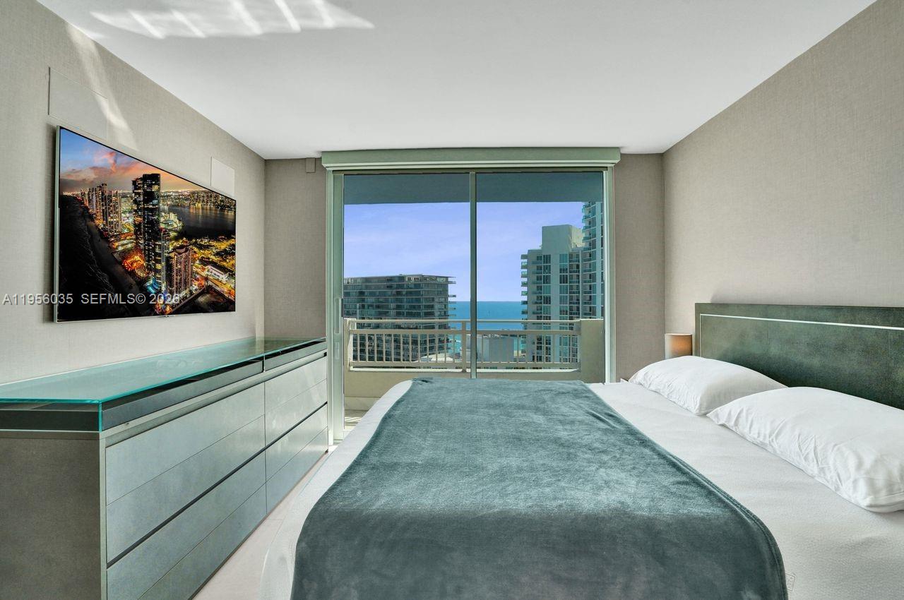 90 Alton Road, Unit 2701 Miami Beach, FL 33139 - Photo 41 of 76 a bedroom with a bed and a large window