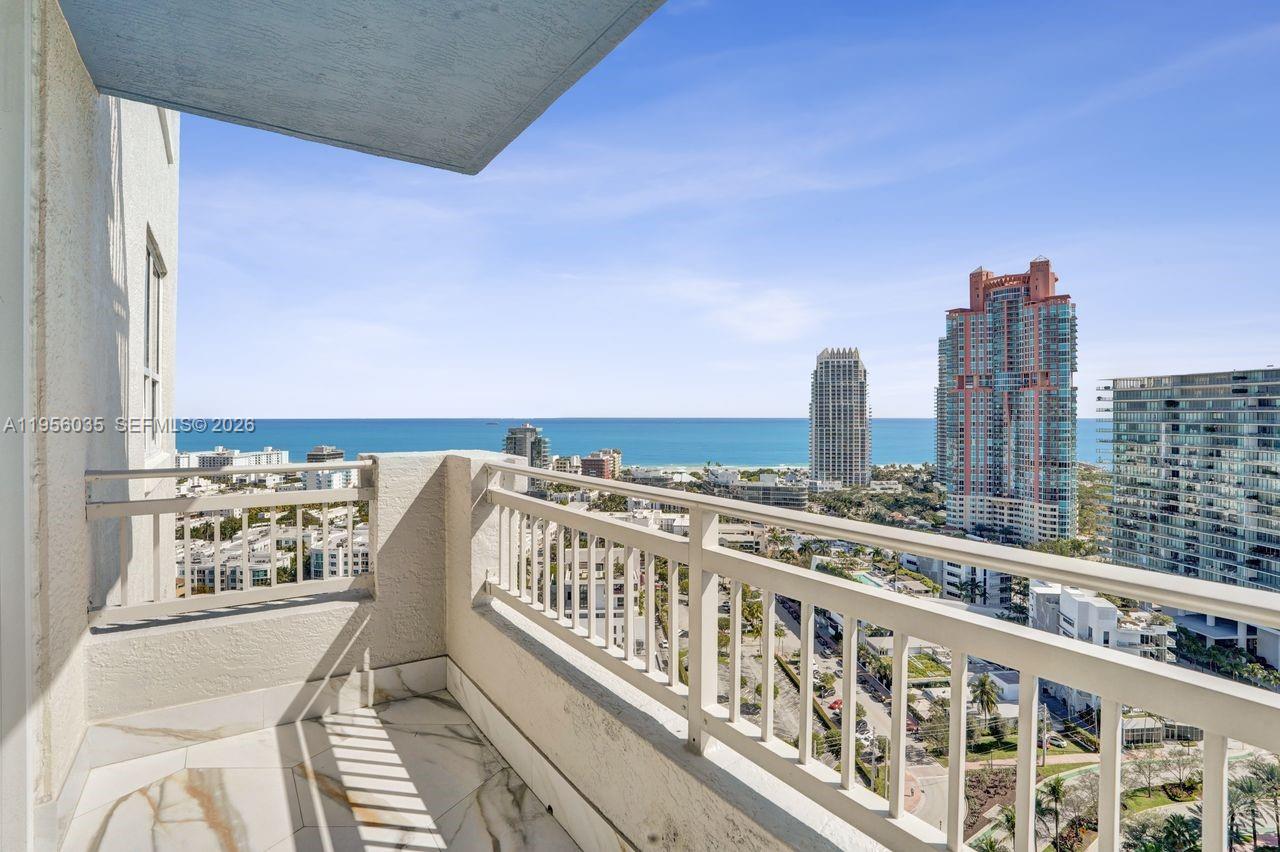 90 Alton Road, Unit 2701 Miami Beach, FL 33139 - Photo 43 of 76 a view of a balcony with wooden chairs