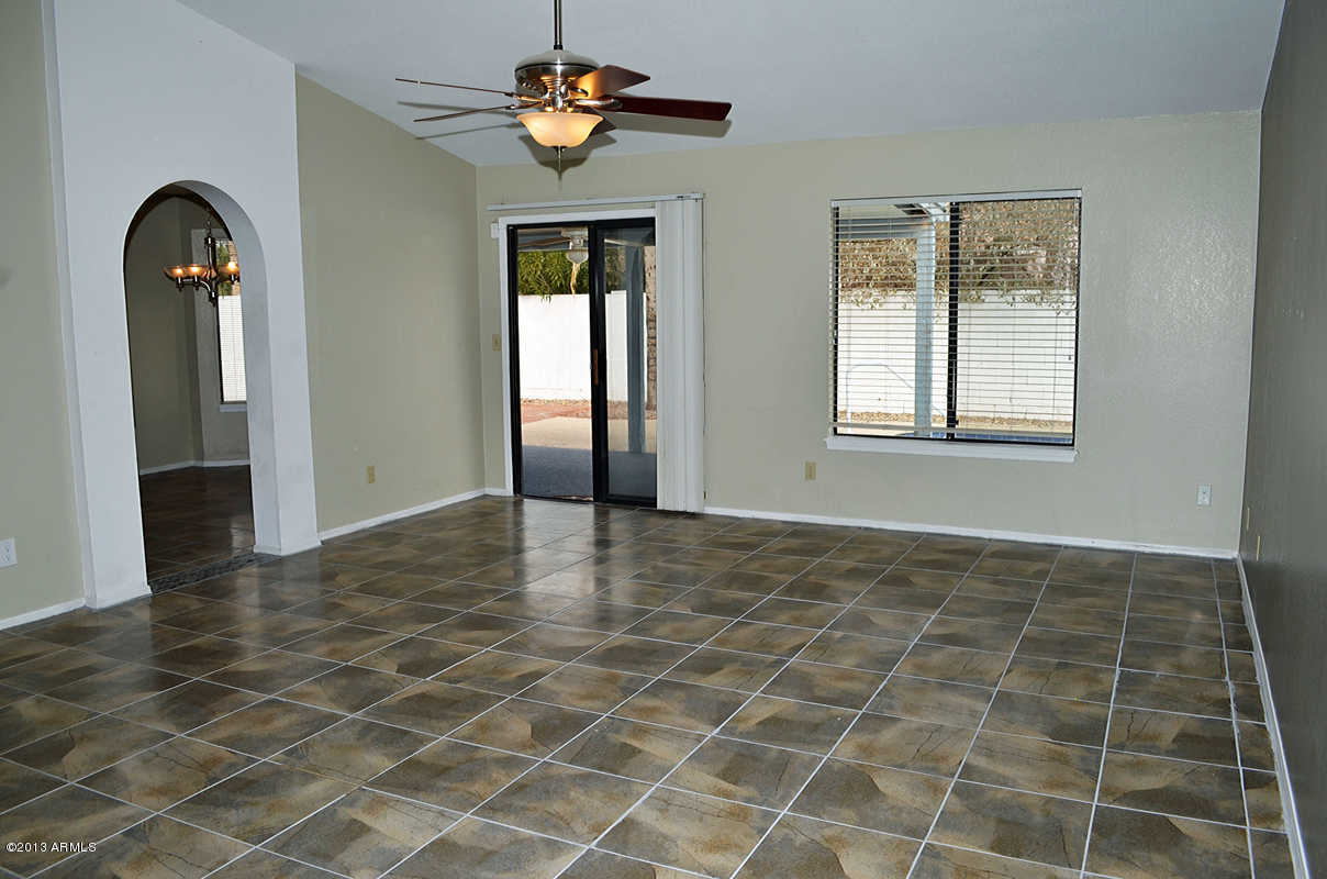 420 East Harwell Road Gilbert, AZ 85234 - Photo 6 of 13 an empty room with windows and ceiling fan