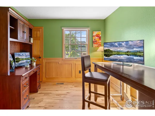 a living room with furniture window and dresser