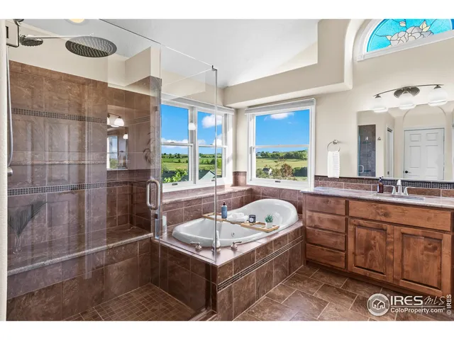 a bathroom with a sink mirror and a bathtub