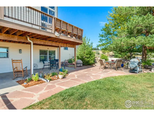 a view of a backyard with plants and lake view