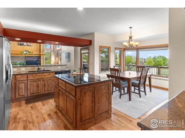 a kitchen with a stove a sink a dining table and chairs