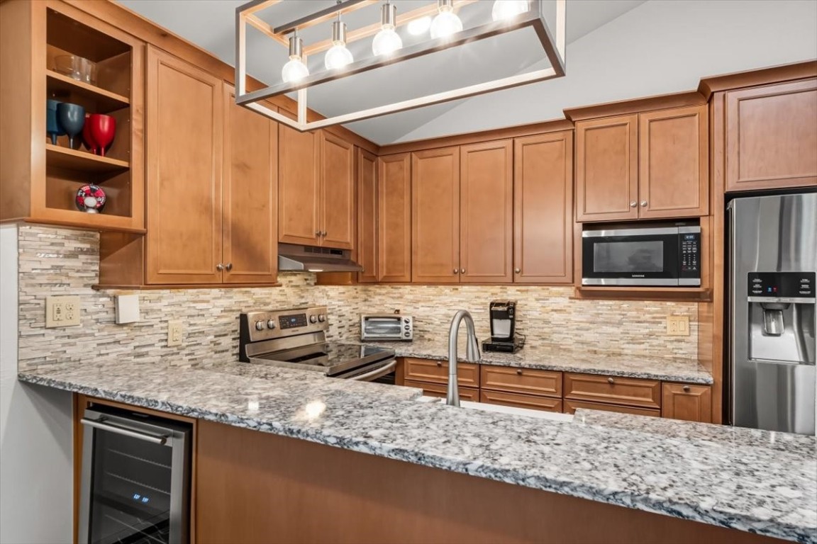1937 Soda Ridge Road, Unit 1159 Keystone, CO 80435 - Photo 2 of 29 a kitchen with stainless steel appliances granite countertop a sink a stove and a microwave oven