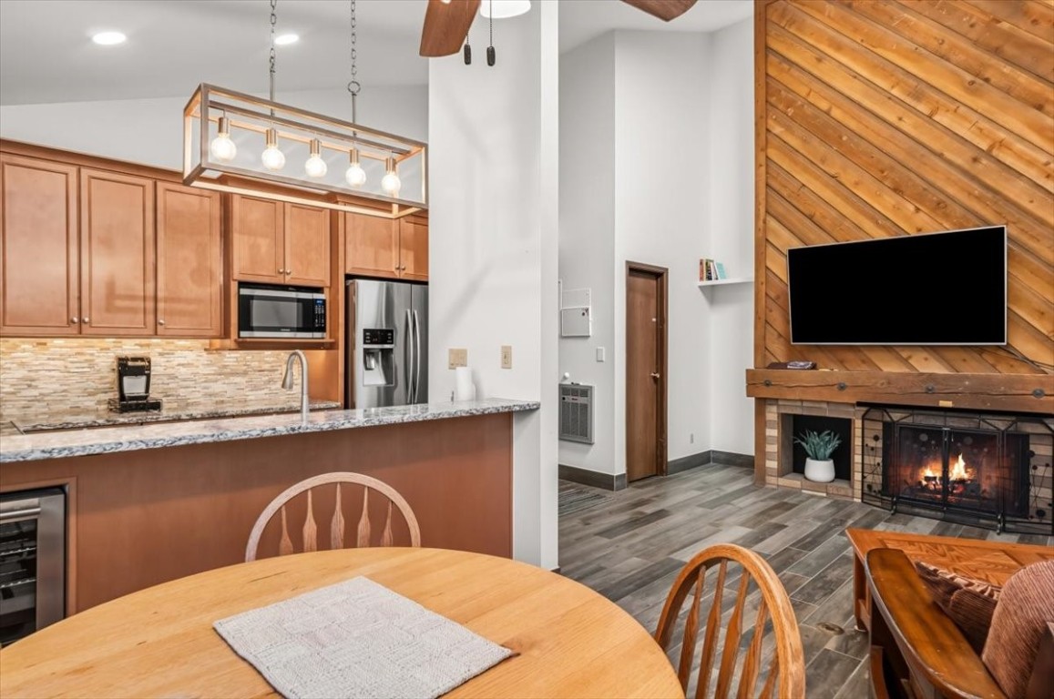 1937 Soda Ridge Road, Unit 1159 Keystone, CO 80435 - Photo 3 of 29 a kitchen with furniture a flat screen tv and a fireplace