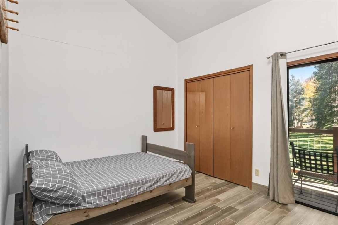 1937 Soda Ridge Road, Unit 1159 Keystone, CO 80435 - Photo 10 of 29 a bedroom with a bed and wooden floor