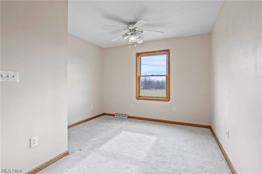 411 Adario West Road Shiloh, OH 44878 - Photo 23 of 35 Carpeted spare room featuring ceiling fan