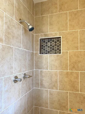 a view of a livingroom with a hardwood floor and a ceiling fan