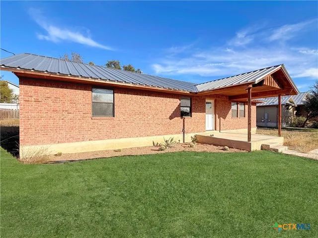 an empty room with wooden floor and a ceiling fan