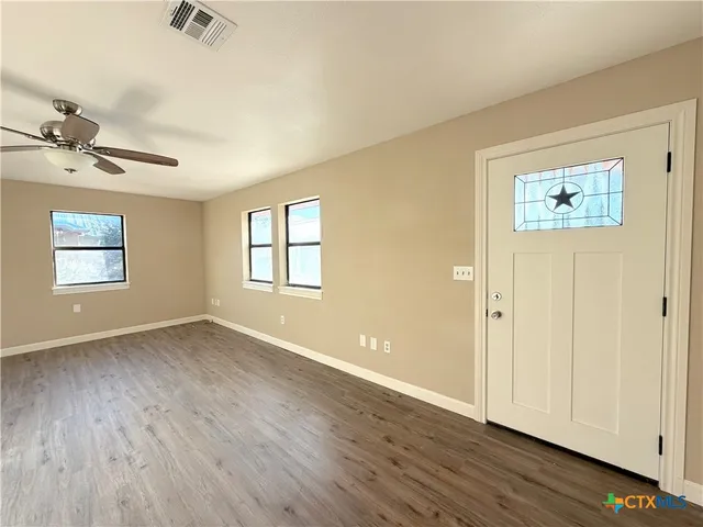 a view of walk in closet with wooden floor