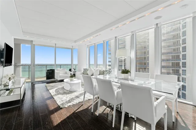 a view of a dining room with furniture windows and wooden floor
