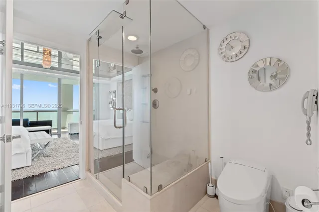 a bathroom with a shower a toilet and sink