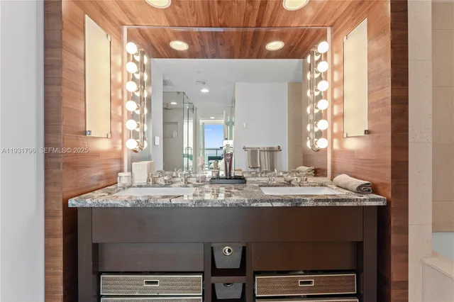 a bathroom with a granite countertop sink and a mirror