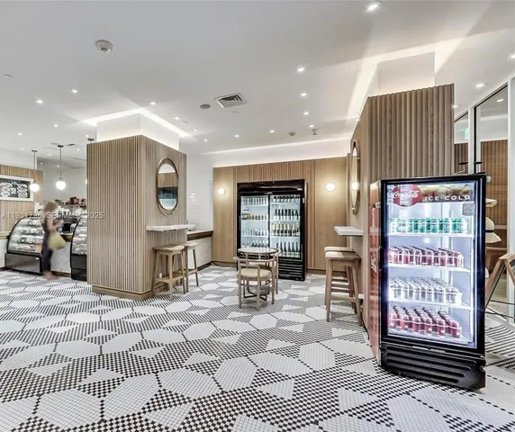 a lobby with furniture and a rug
