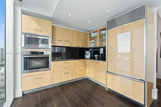 a kitchen with stainless steel appliances a refrigerator and a stove top oven