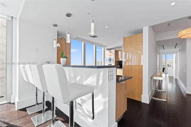 a view of a kitchen with furniture and wooden floor
