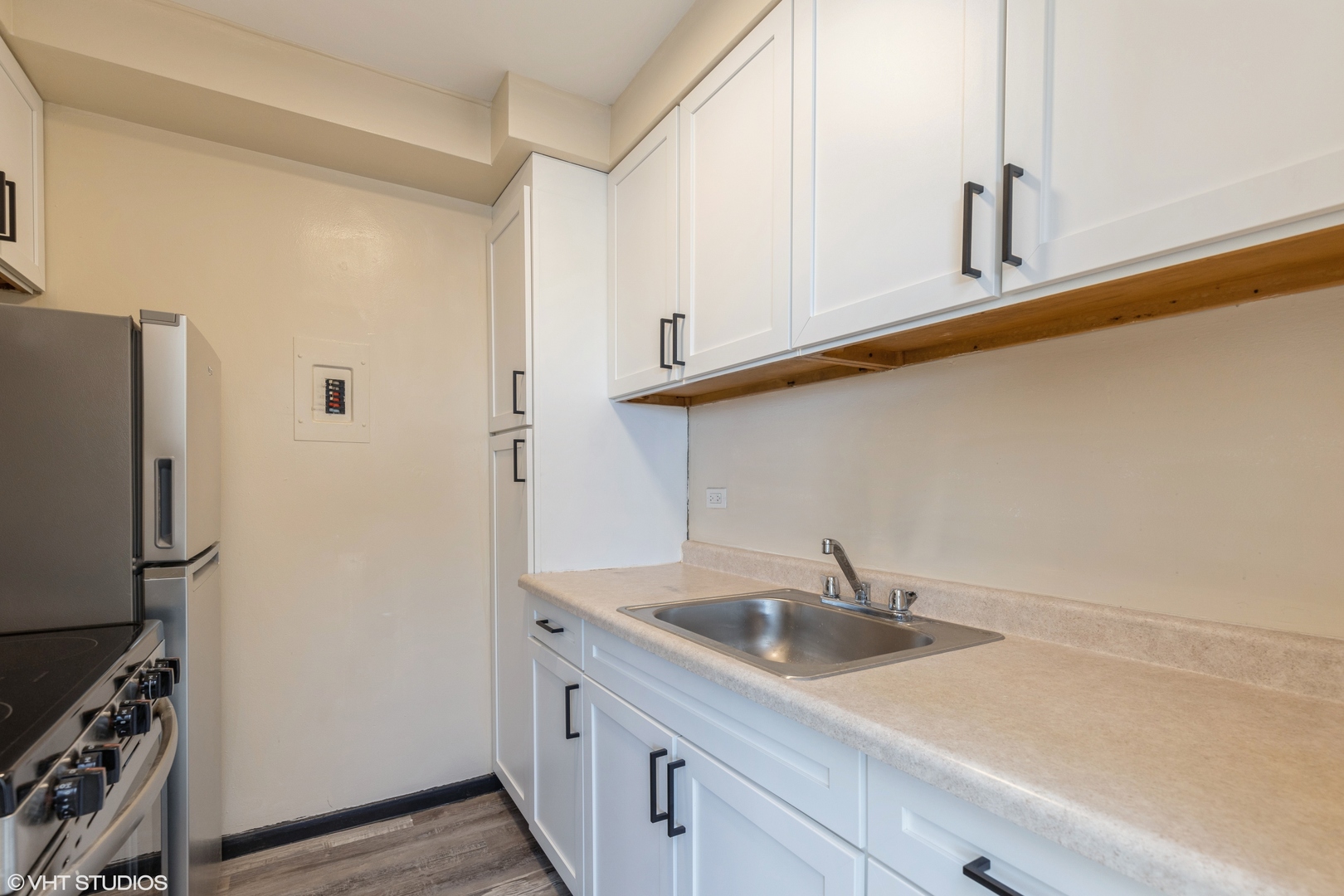 1400 Chicago Avenue, Unit 802 Evanston, IL 60201 - Photo 4 of 9 a kitchen with stainless steel appliances a sink a refrigerator and cabinets