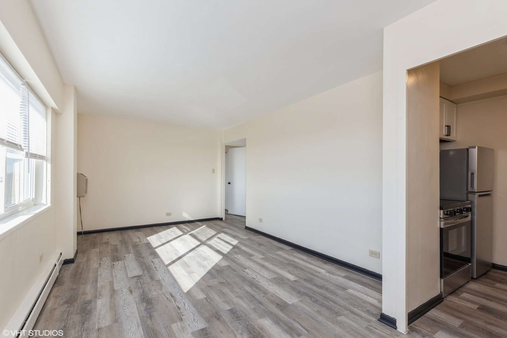 1400 Chicago Avenue, Unit 802 Evanston, IL 60201 - Photo 6 of 9 wooden floor in an empty room with a window