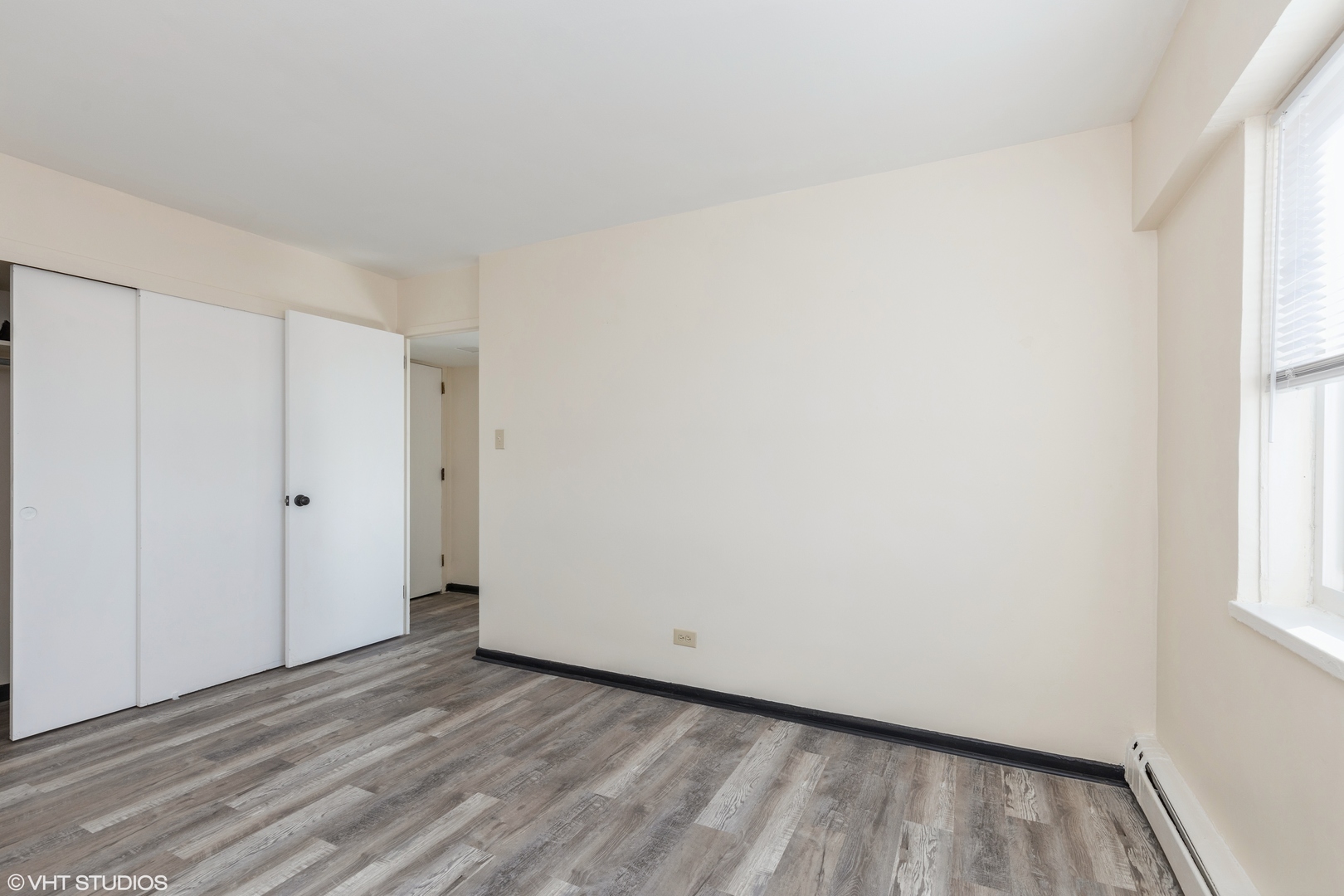 1400 Chicago Avenue, Unit 802 Evanston, IL 60201 - Photo 9 of 9 a view of a room with wooden floor and window