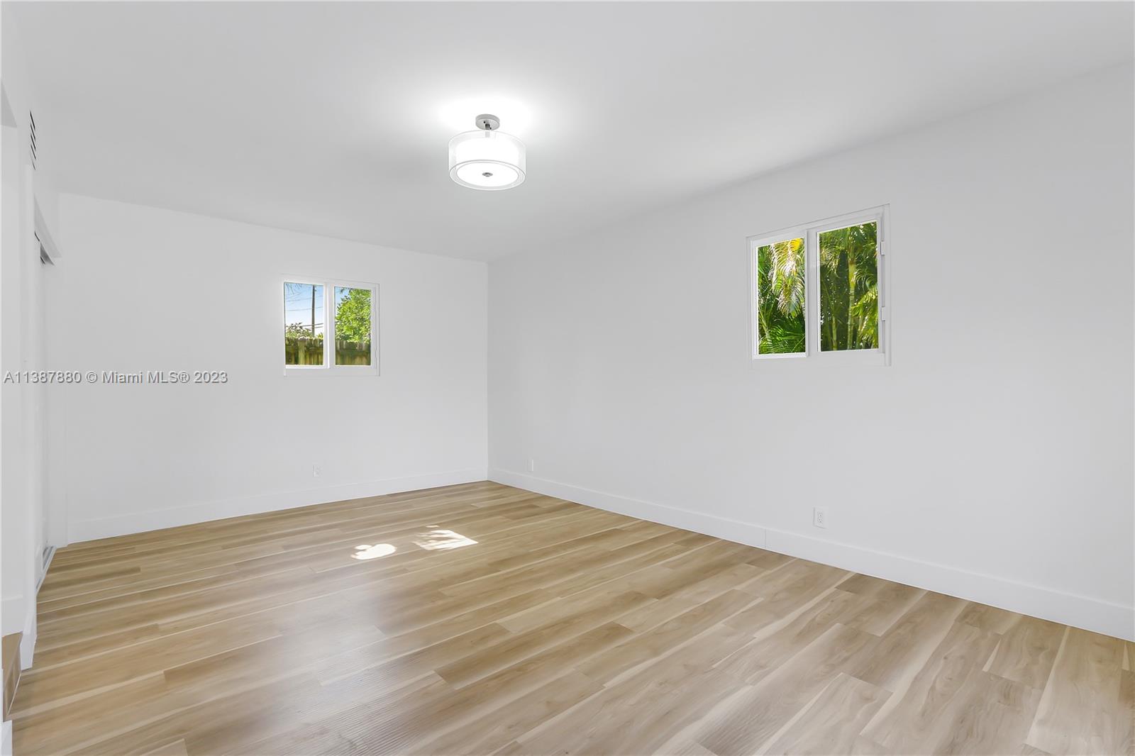 269 Northwest 12th Street Boca Raton, FL 33432 - Photo 13 of 18 a view of empty room with window and wooden floor