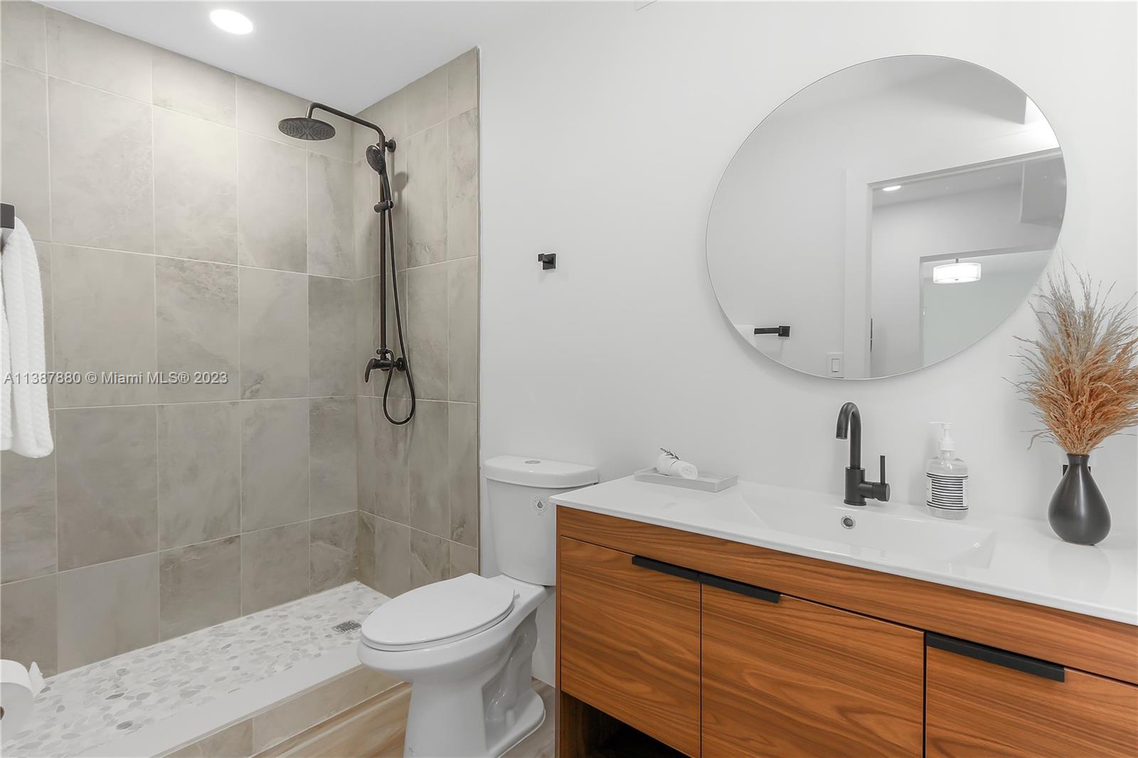 269 Northwest 12th Street Boca Raton, FL 33432 - Photo 14 of 18 a bathroom with a sink a toilet and shower