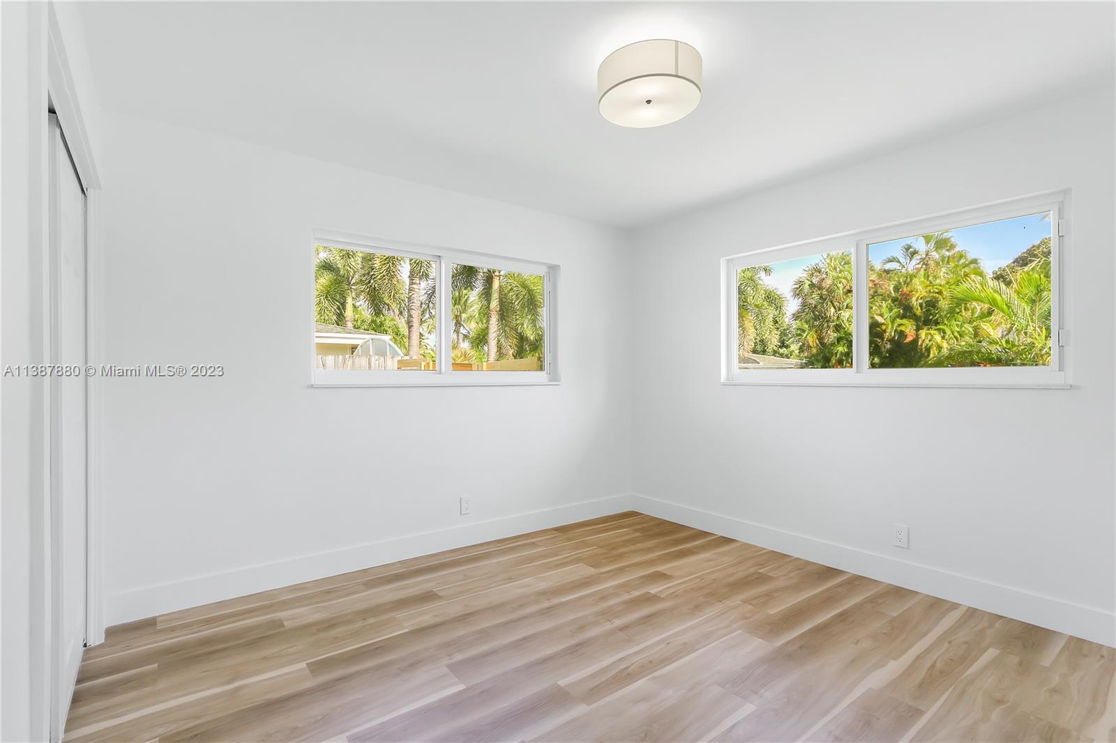 269 Northwest 12th Street Boca Raton, FL 33432 - Photo 16 of 18 a view of empty room with wooden floor and window