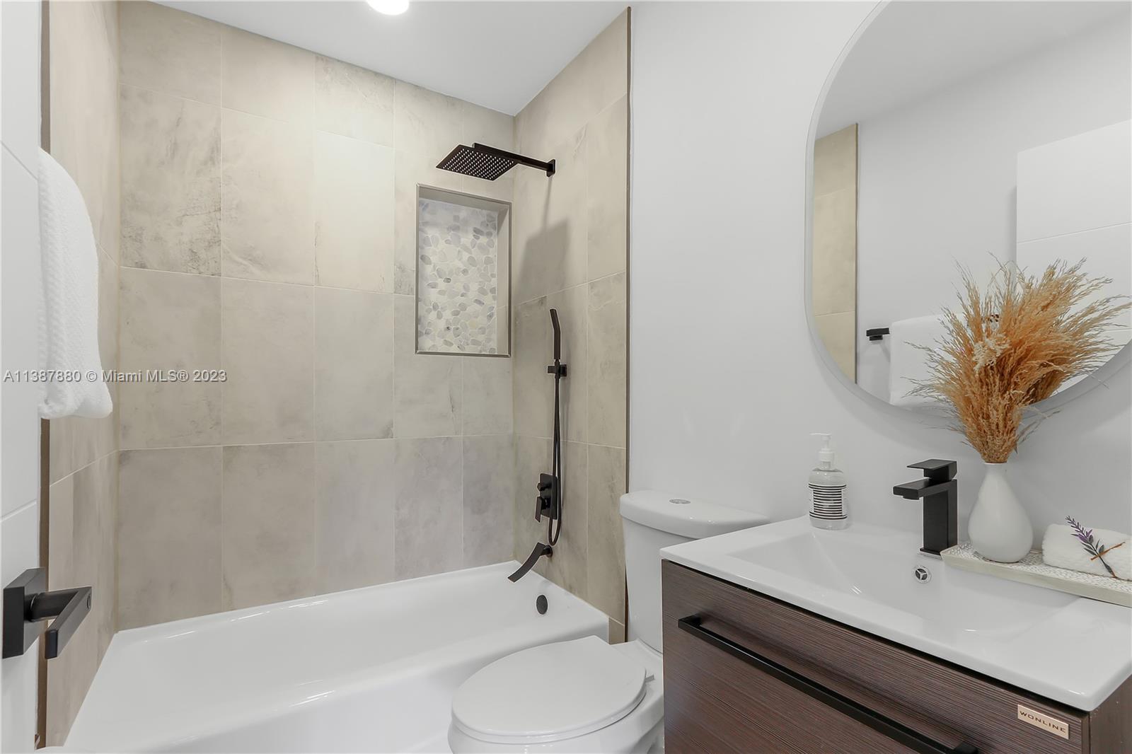 269 Northwest 12th Street Boca Raton, FL 33432 - Photo 17 of 18 a bathroom with a sink a toilet and shower