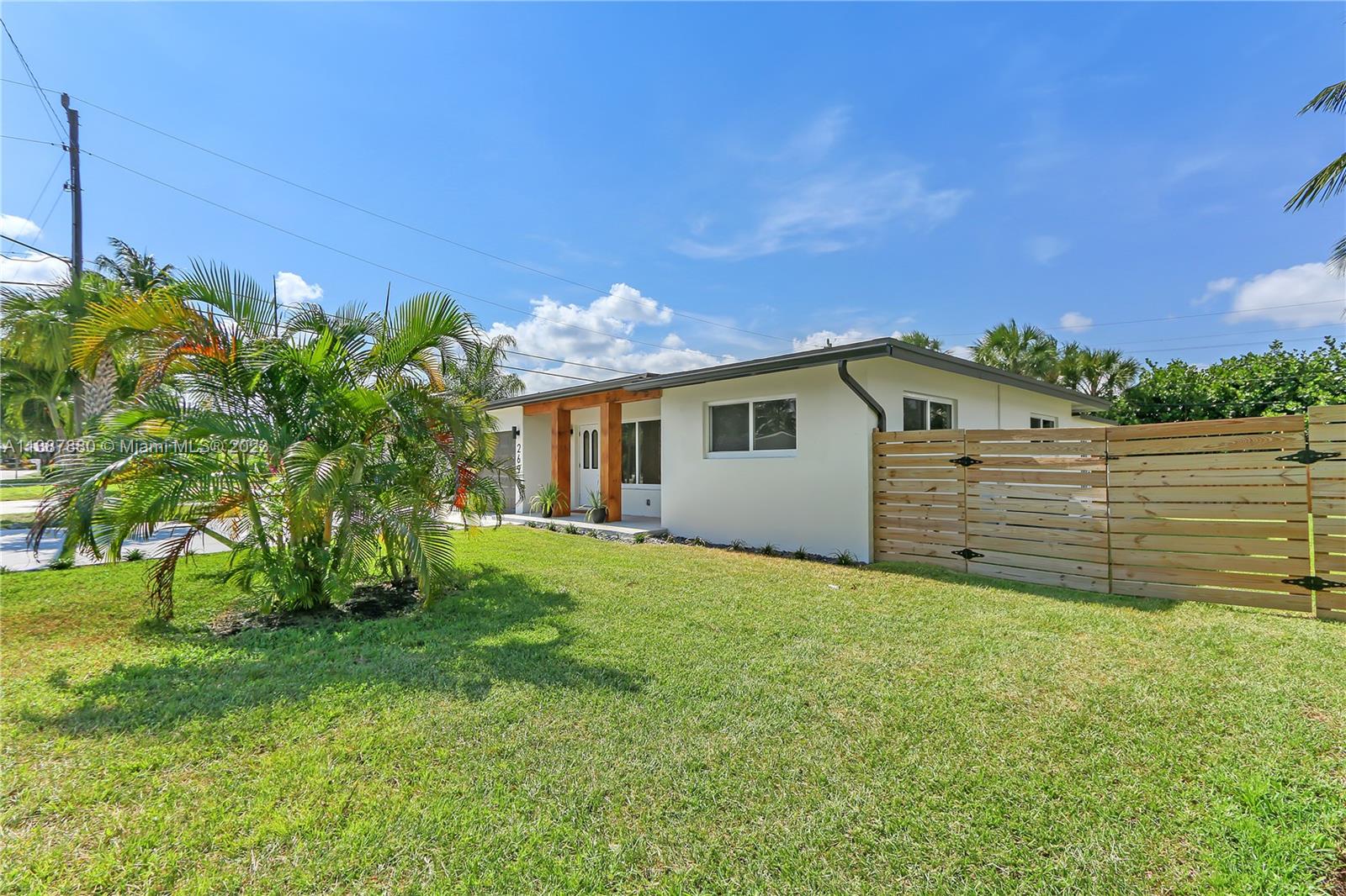 269 Northwest 12th Street Boca Raton, FL 33432 - Photo 3 of 18 a view of a backyard with plants and a large tree